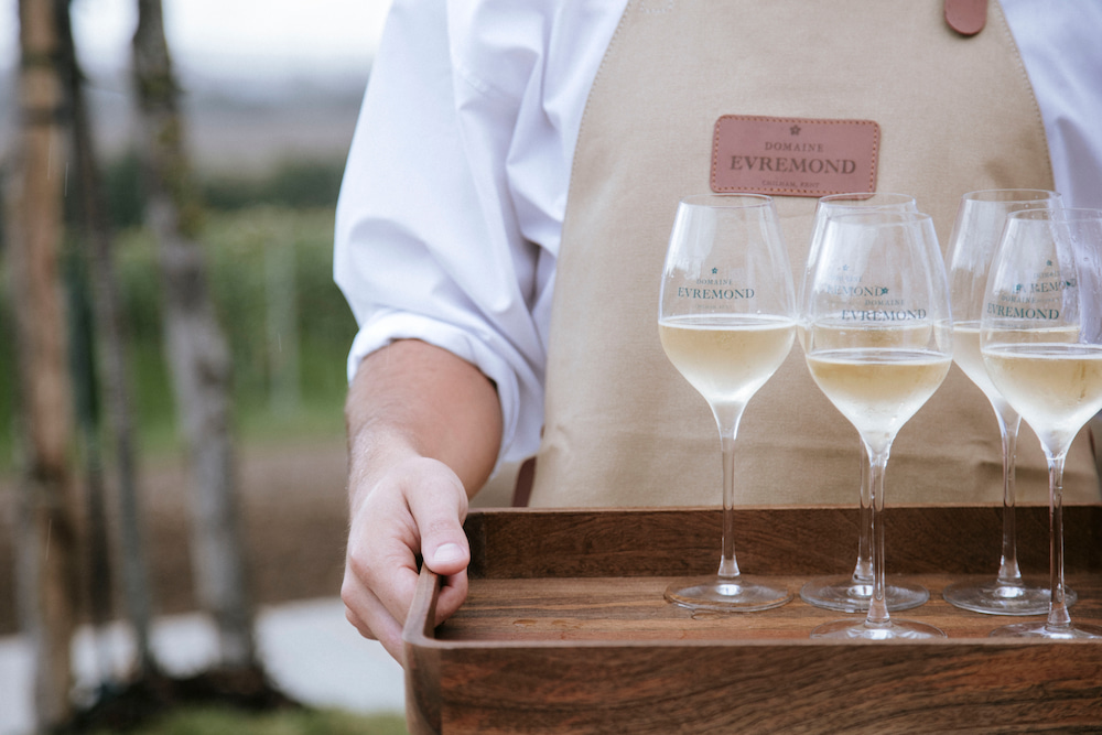 Domaine Evremond Glasses of Domaine Evremond being handed out at an event.