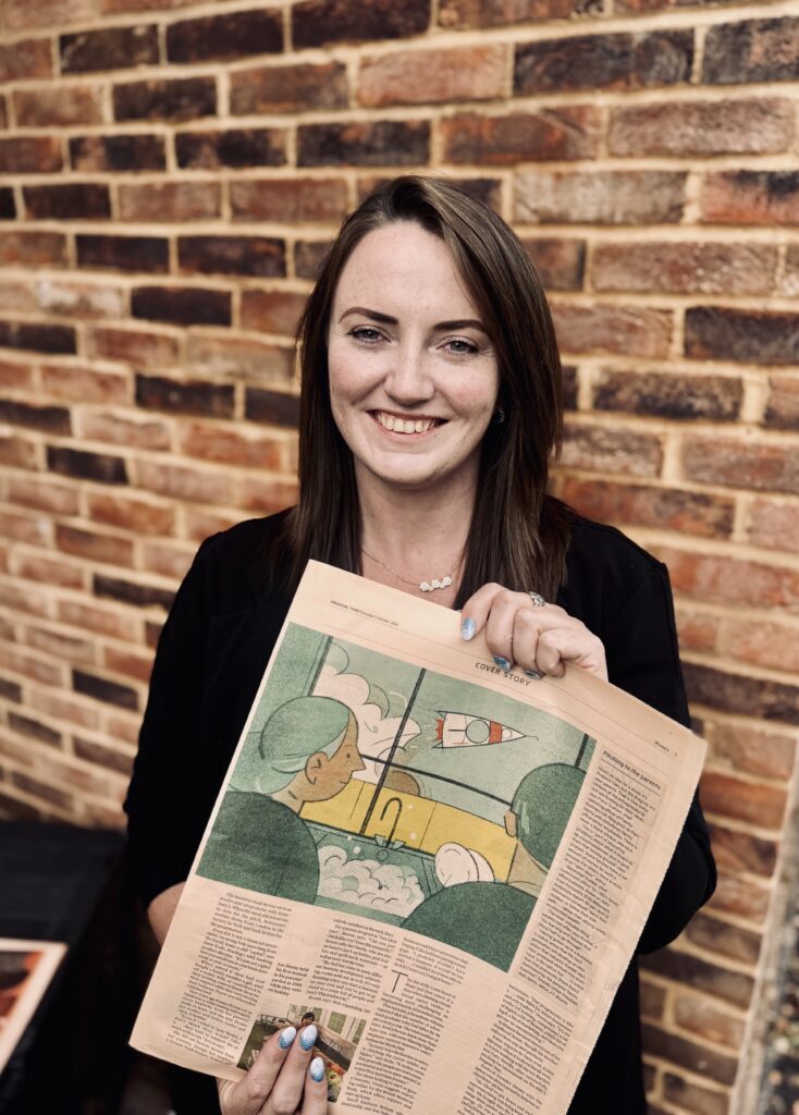 Opulence founder Emma Broom holding the Financial Times newspaper featuring her business story.
